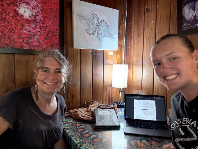 Katie Allen and Rebecca means sit together at a local coffee shop.