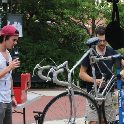 Two People Fixing a Bike