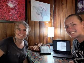 Katie Allen and Rebecca means sit together at a local coffee shop.
