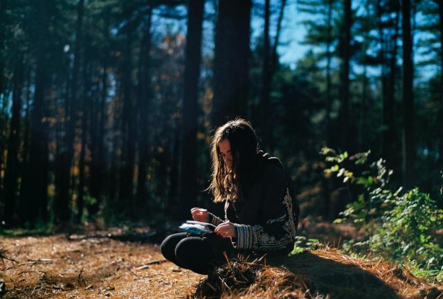 woman writing outdoors