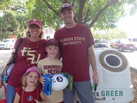 family at football game recycling