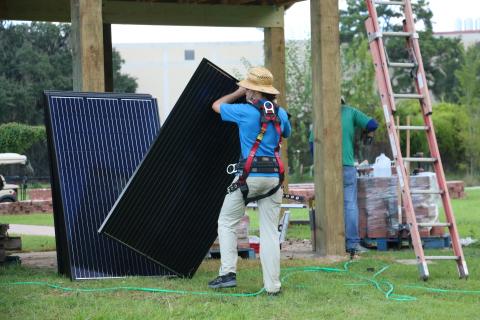 Man holding solar panel