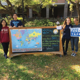 Students with World Water Day Chalkboard Sign
