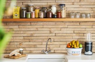 food on shelf behind kitchen sink