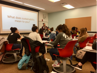 Design students watch a presentation by Sustainability Director Elizabeth Swiman